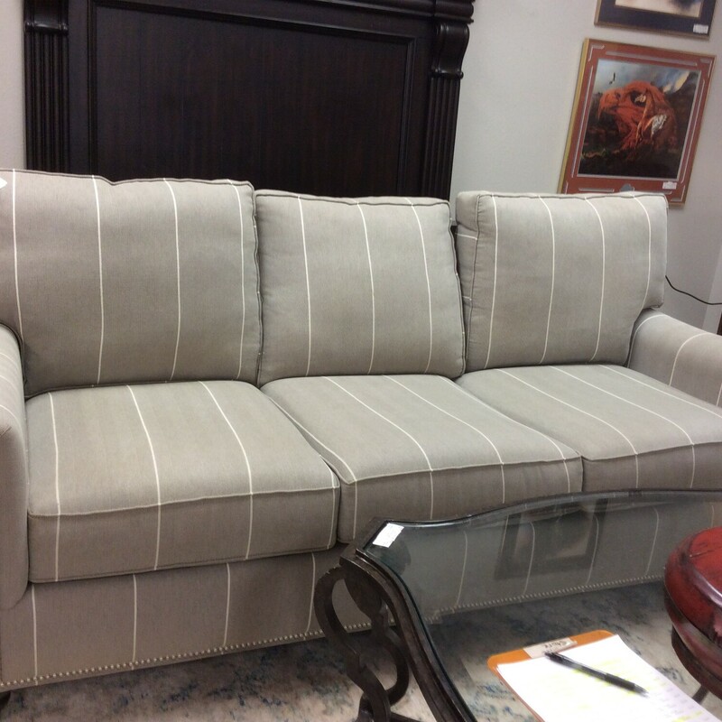 This is a Grey with White stripe 3 seater linen Bassett Sofa. This Sofe features Nailhead trim and dark brown wood circled feet