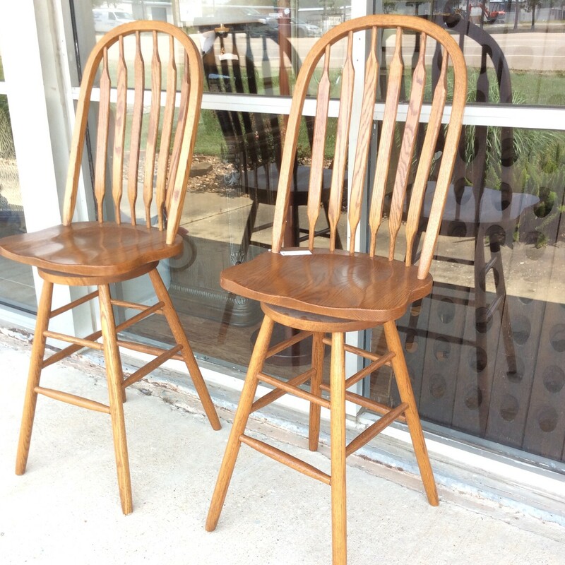 These Oak Wood Bar Stools were made by The Amish Oak Furniture Company. These Chairs also rotate for easier mobility to get in and out of the chairs.