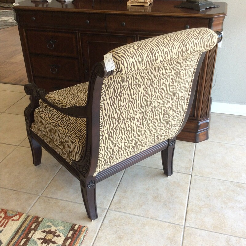 This is a Brown and Cream Zebra Accent Chair. This Chair has Dark Wood Stained detailed arm and foot rails.