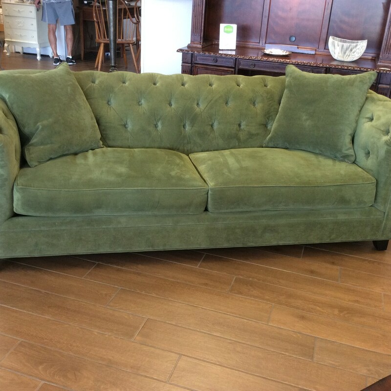 This is a Martha Stewart Tuffeted Back Green Sofa. This sofa has Dark Stained Wood Legs and comes with 2 Green accent pillows.