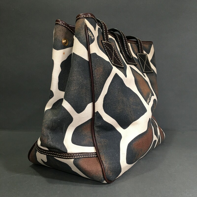 Dooney & Bourke Giraffe, Pattern, Size: Large<br />
Condition:	Pre-owned<br />
<br />
12 in x 10 in x 6 in<br />
<br />
Exterior Material: Canvas & Leather<br />
Black  cream and brown,  Lightweight Shoulder Bag<br />
 with Dooney & Bourke signature metal bag charm.<br />
Dark brown leather strap and gold hardware, (5) grommets on bottom on bag, pink canvas interior wth zip wallet pocket and separate phone pocket<br />
<br />
1 lb 1.5 oz