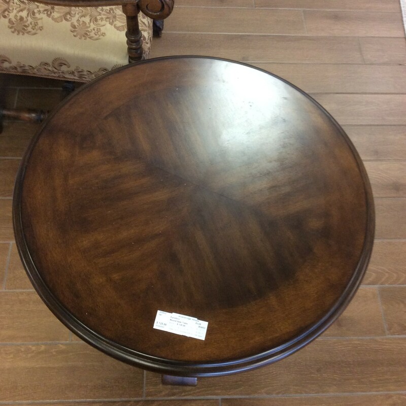 This is a beautiful Dark Rustic Finish Round side table. This Table has circle detail trim with 3 swirled feet.