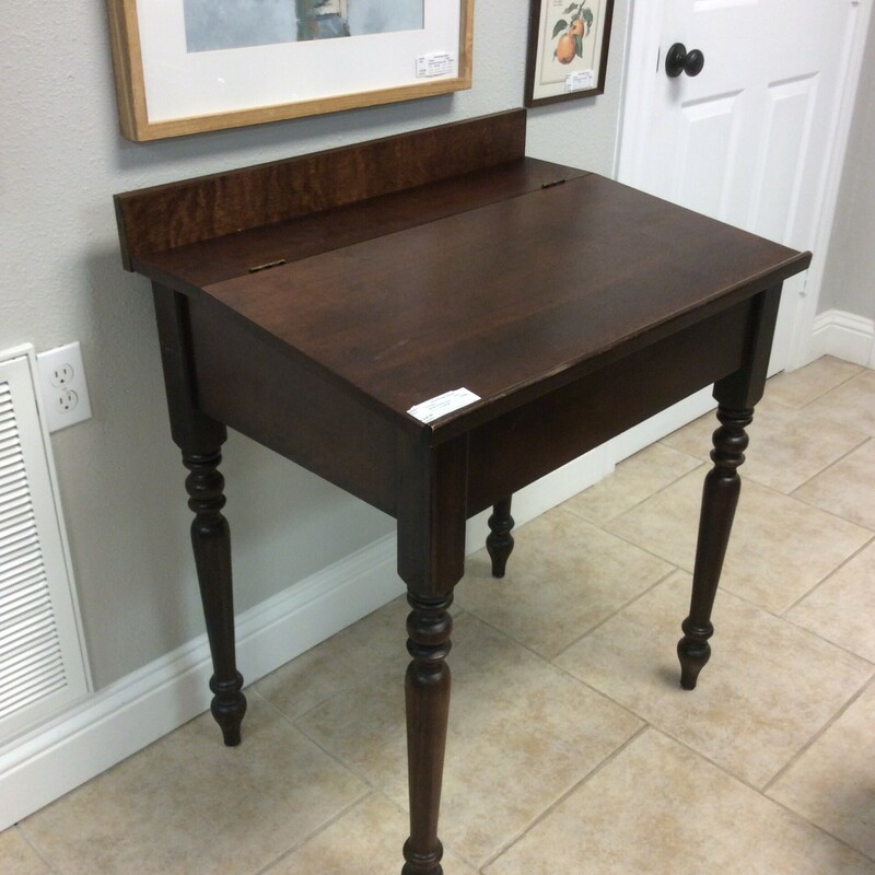 This handsome little writing desk has a lift up top of storage.