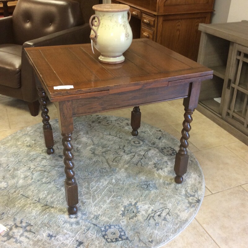 This is a beautiful Antique Dark Stained Wood. This Table has Barley Spindal Legs.