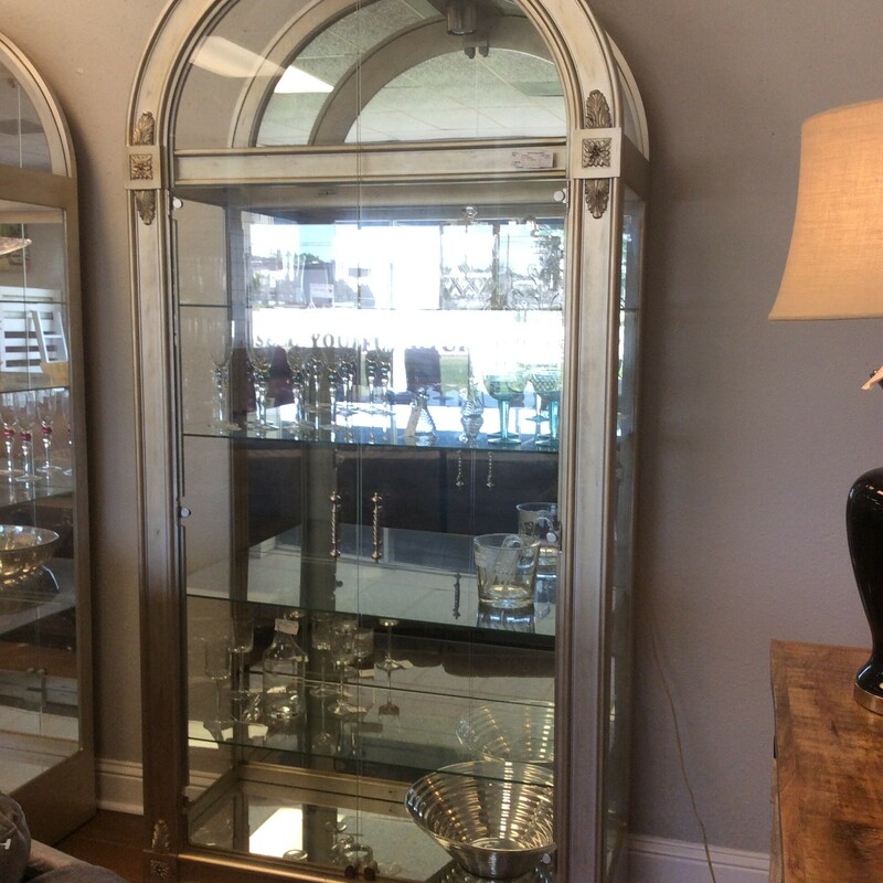 This is a beautiful Howard Millar Silver & Glass Curio Cabinet. This Curio has Double Glass Doors with Silver Handles, Mirrored Back and Bottom, 1 Light and 5 Adjustable Shelfs.