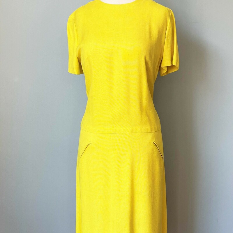 This is something I could see Twiggy wearing.  It is so cute.<br />
Yellow Dress from the 1960s.<br />
Short Sleeves<br />
Dropped Waist<br />
The fabric is a slubby linen or linen blend, no fabric tags present<br />
Center back<br />
Unlined<br />
union made<br />
By Madison<br />
<br />
Here are the flat measurements, please double where appropriate:<br />
Shoulder to shoulders: 16<br />
armpit to armpit:19<br />
Waist: 18<br />
Hip: 21<br />
Length: 34<br />
<br />
Thank you for looking.<br />
#47939