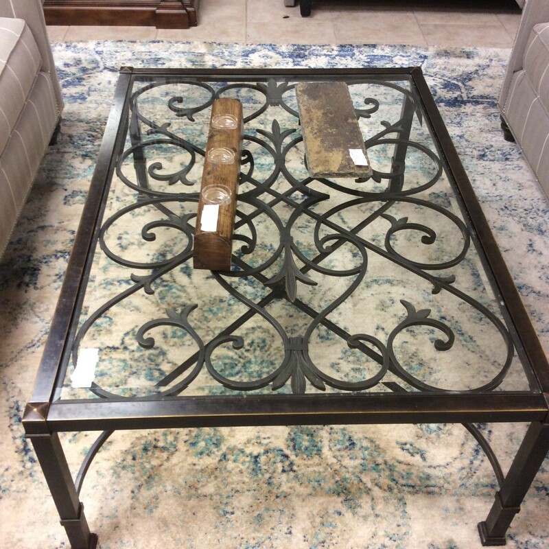 This is a Rod Iron Rustic Ethan Allen Cocktail Table. This Cocktail Table has a glasstop and Rod Iron Swirl Detailing.