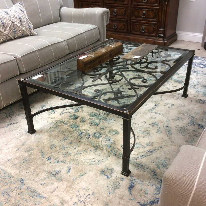 This is a Rod Iron Rustic Ethan Allen Cocktail Table. This Cocktail Table has a glasstop and Rod Iron Swirl Detailing.