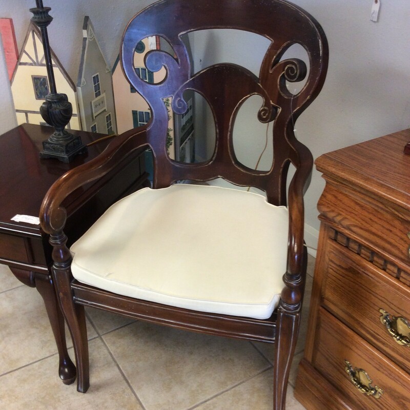 This is a Distressed Dark Stain Accent Chair. This Chair has Swirl Accent and Tappered Legs. This Chair also features a Wicker Bottom and Removable Cream colored Cushion.