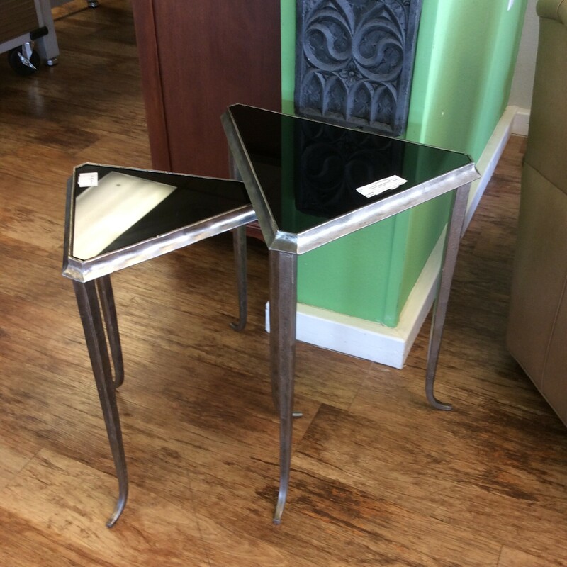 These are Misha Triangle Nesting Tables. These Table have a stainless steal trim and legs and a black glass top.