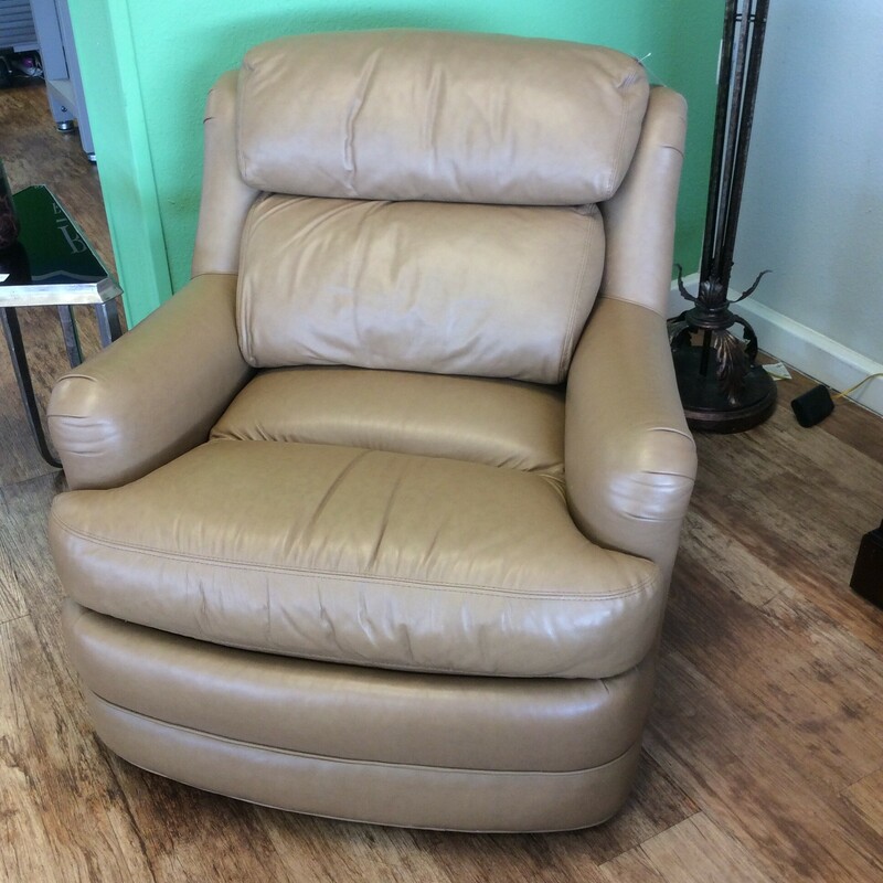 This comfy  chair is upolstered in a soft tan leather.  Could be used in a variety of settings.