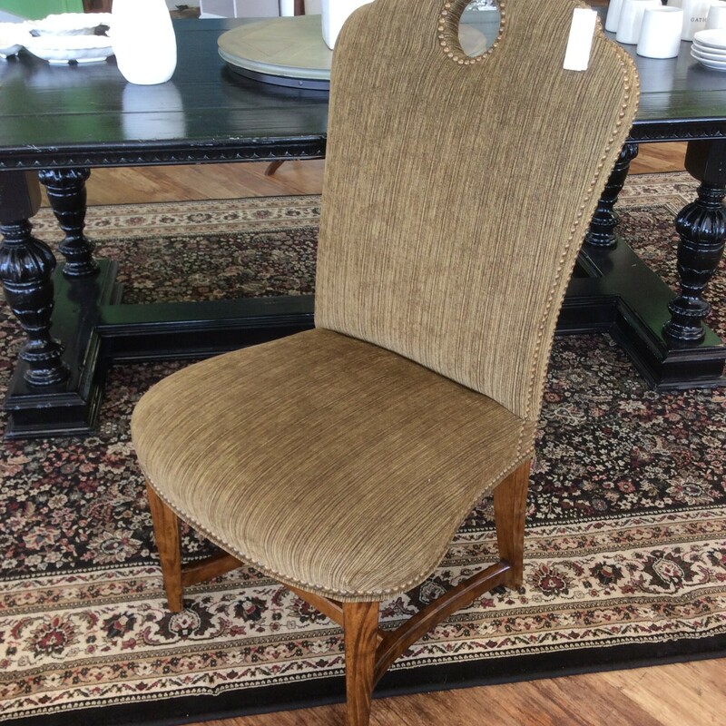 This upholstered chair by Century is very stylish. It has a sculpted back with a circular opening and nail head trim. It upolstered in an olive chenille fabric.