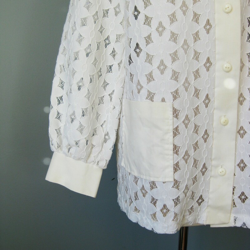 This white lace blouse from the 1960s is so feminine.<br />
It might even be a maternity top with it's swingy shape.<br />
The front and sleeves are unlined lace<br />
the yoke and cuffs are a thin cotton or cotton poly blend.<br />
the lace is bright white but the yoke and cuffs have mellowed to an offwhite color.<br />
Otherwisse in perfect condition<br />
Buttons down the front and on the cuffs<br />
No tags<br />
Here are the flat measurements:<br />
shoulder to shoulder: 14 3/4<br />
armpit to armipt: 21 1/2<br />
width at hem: 24<br />
Length from neck to hem: 28 3/4<br />
<br />
thank you for looking.<br />
#36606