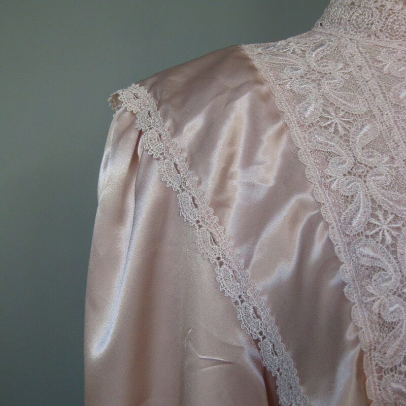 Vtg San Andre Satin, Pink, Size: 10<br />
Here is a big shouldered pink secretary blouse with a deep draped shawl collar, with a big lace panel in the front.<br />
It's made of soft satin polyester and buttons in the back<br />
There are drapes of the illusion lace on each shoulder.<br />
It was made in 1993, the label actually has a date on it!<br />
Brand: San Andre<br />
Big shoulders pads<br />
<br />
Marked size 10.<br />
Here are the flat measurements, please double where appropriate:<br />
Shoulder to shoulder: 17<br />
Armpit to armpit: 20.25<br />
Width at hem: 22<br />
Underarm sleeve seam: 20.5<br />
Length: 24<br />
Perfect condition<br />
Thanks for looking!<br />
#42852