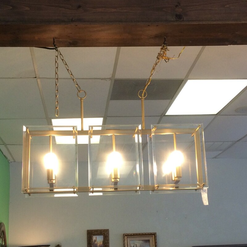 This is a beautiful 6 bulb, gold, rectangle chandelier. This chandelier also has square glass to frame the bulbs.