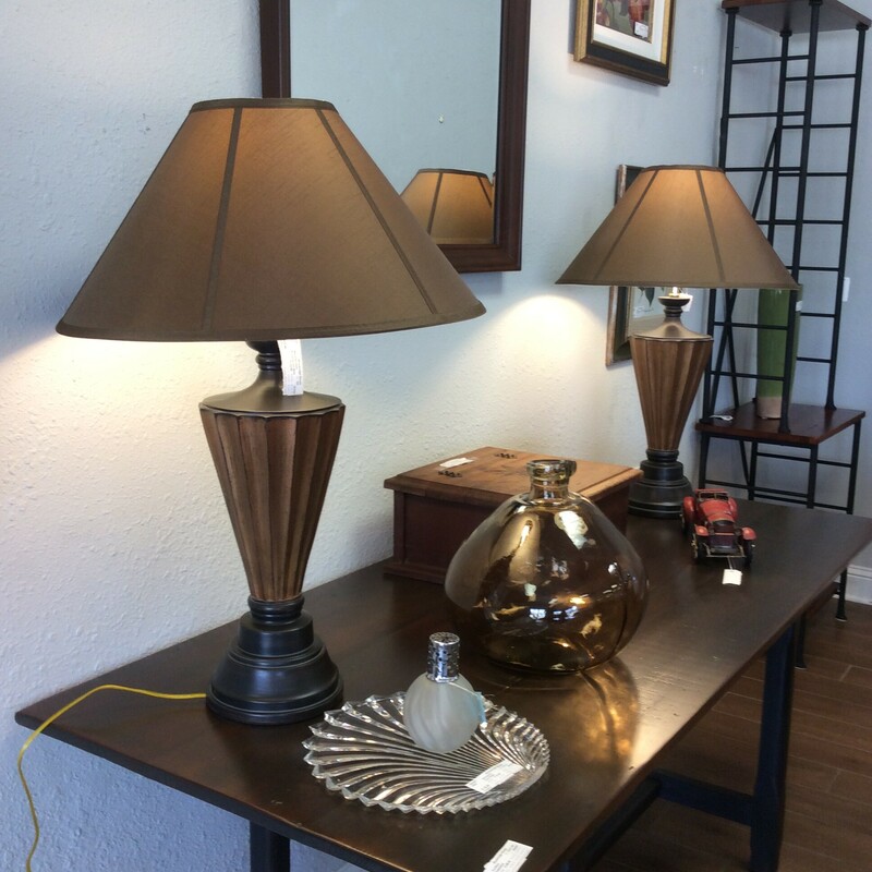 These are a pair of urn based lamps. These lamps have a light and dark brown distressed finish and a nice light brown shade.