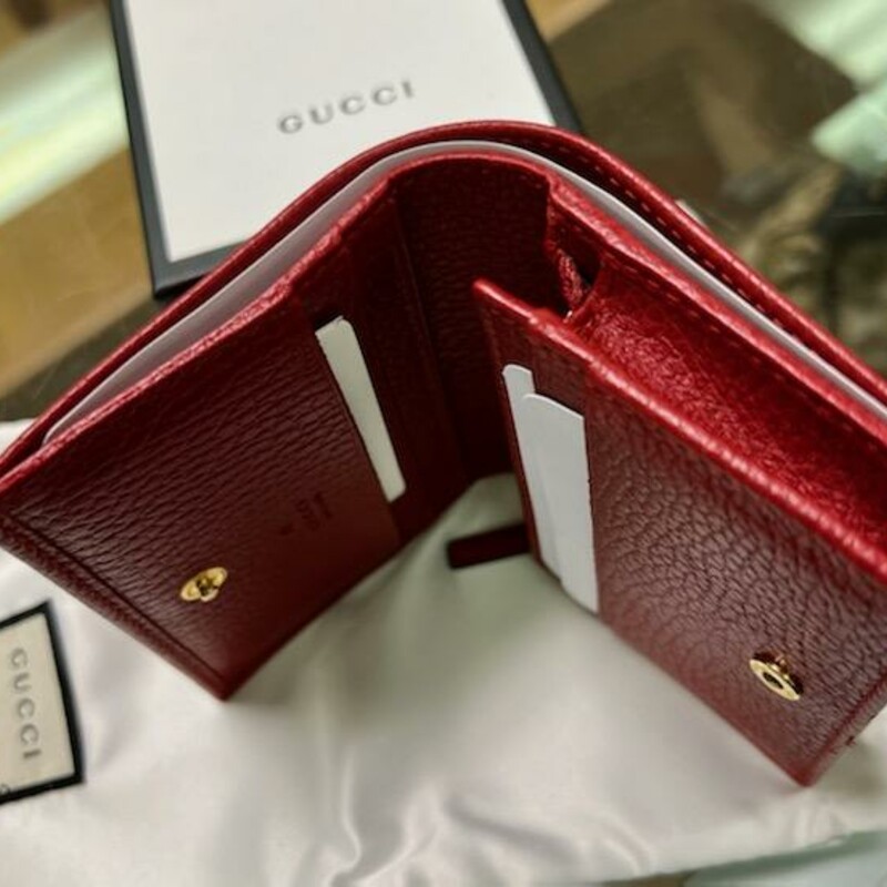 GUCCI<br />
NET SUSTAIN Marmont Petite textured-leather wallet<br />
Gucci's wallet is part of the label's coveted 'Marmont' family - the overlapping gold monogram on the front is a dead giveaway. Made in Italy from chrome-free tanned textured-leather, it opens to five card slots and a zipped pocket for coins.<br />
This product was created using Considered Processes, which is Net Sustain - the opportunity to invest in sustainable luxury.<br />
Style ?456126 CAO0G 6433<br />
A card case wallet with small Double G metal detail. Made in textured leather.<br />
DETAILS:<br />
-Hibiscus red metal-free tanned leather<br />
-Gold-toned hardware<br />
-Double G<br />
-Five card slots<br />
-One bill compartment<br />
-Interior zipper pocket<br />
-Snap closure<br />
-Open: W11cm x H17.5cm<br />
-Closed: 4.3\"W x 3.3\"H x 1.2\"D<br />
-Made in Italy<br />
The Original Retail price on this wallet is $460.00 avaiable online with GUCCI NOW!<br />
The Wallet does come with the Original Dust cover and GUCCI box.<br />
The wallet is in excellent condition, No flaws found on the leather, very well cared for.  Only the GUCCI gold in te front shows signs of wear.<br />
TheRealReal has this wallet for resale without the box & bag for $325.00