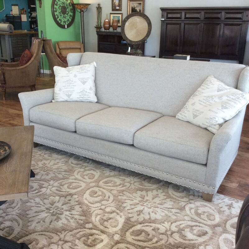 This beautiful Craft Master sofa is upholstered in a off white linen material with nailhead trim details.
