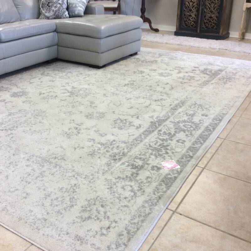 The area rug by Safavieh has gray and silver tones in a washed finish.