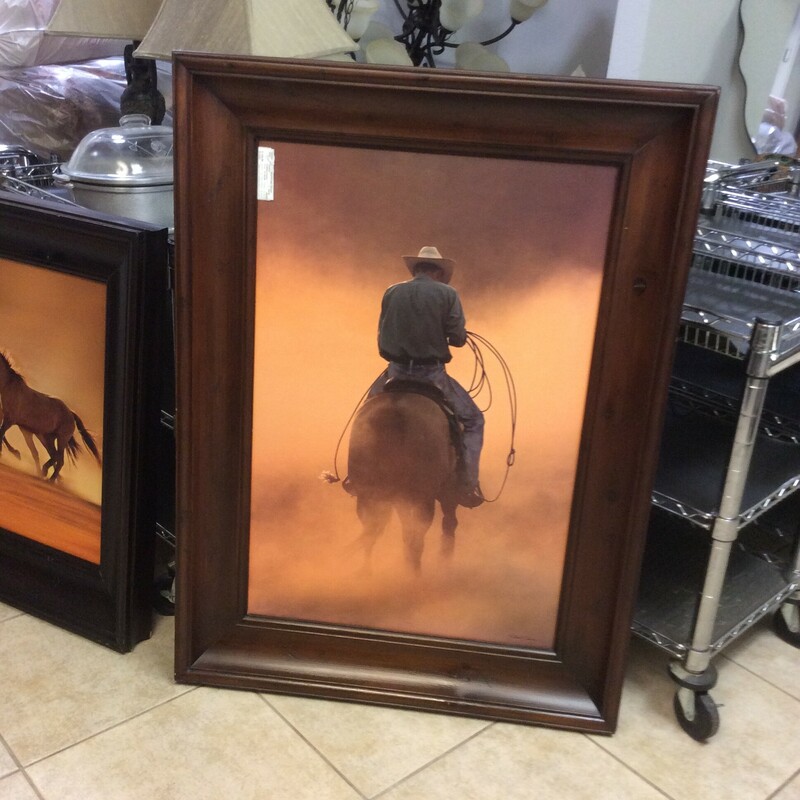 This cowboy print is framed in an oversized rustic wood frame. Definitely a statement piece.