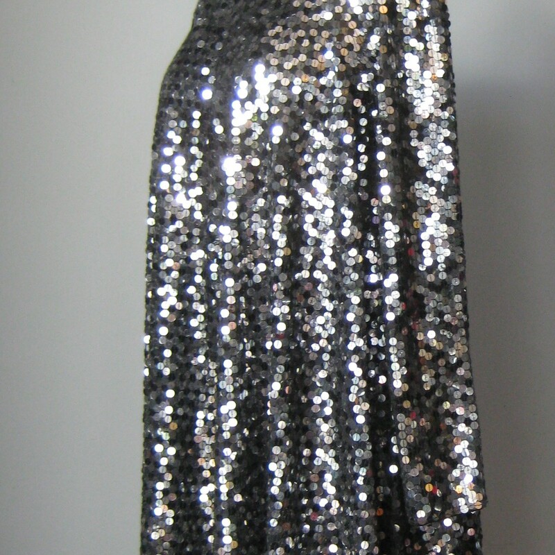 Vtg Oleg Cassini Sequined, Black, Size: 10
Here is a great cocktail dress.  It's by Oleg Cassini's Black Tie line.  It's totally covered with shiny black/silver sequins.  It has long  sleeves and a high neck and a super comfortable swing trapeze silhoutte so it's completely free at the hips and the waist.

Marked size 10, but should fit larger, don't get it if it seems a little big for you.  It's a lot of dress and you don't want to be swamped by it.  Look for it to fit you perfectly at the bust (measure yourself with you very best uplifting bra on your body, IMO best for a tall girl (look at that sleeve length!)

Here are the flat measurements, please double where appropriate

Armpit to Armpit: 21
Waist: 27
Hips: 34
Underarm sleeve seam length: 18
Width at Hem: 50
Length: 37

Thank you for looking.
#42957