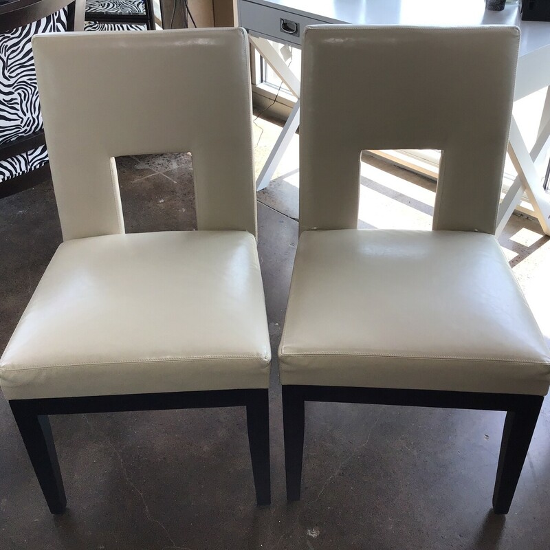 This beautiful cream faux leather chairs from Pier 1 would be perfect for a bedroom, family room or den. The set features a square back with open area and dark wooden legs.
Dimensions are 20 in x 20 in x 36 in