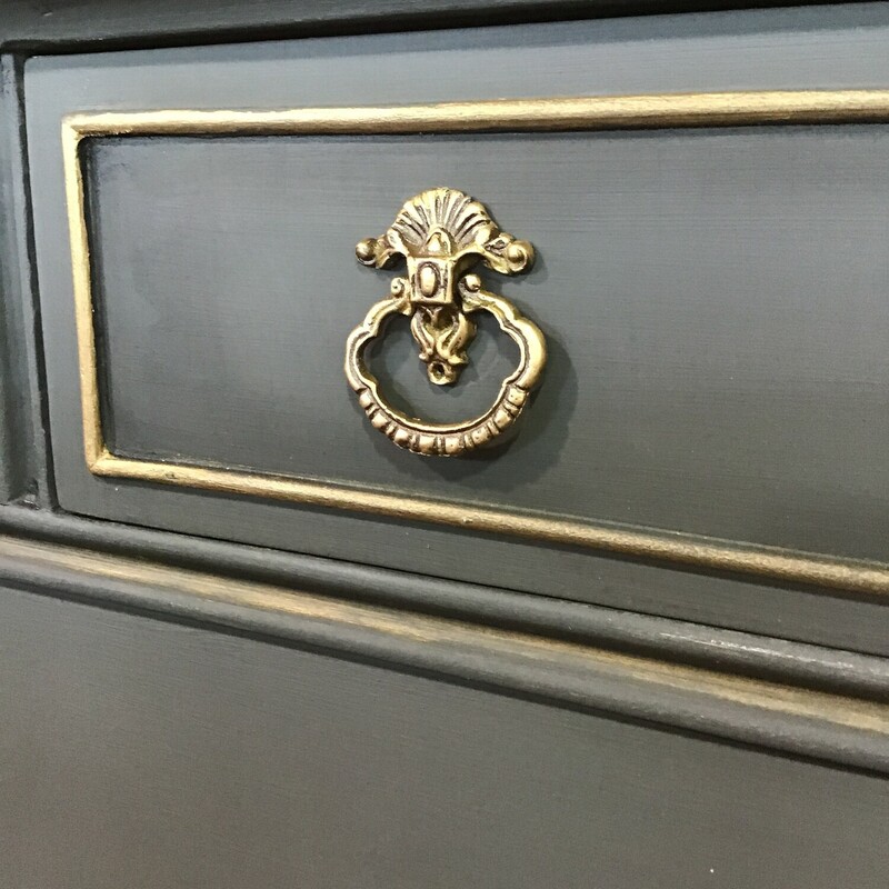 This beautifully updated vintage dresser was painted by one of our local artists using Country Chics Rocky Mountain paint. She used clear wax as a protectant and gold wax for highlights. The hardware was also updated to a gold finish. It has 4 drawers, which all move in and out smoothly. Great accent piece for any room!<br />
Dimensions are 44 in x 22 in x 35 in