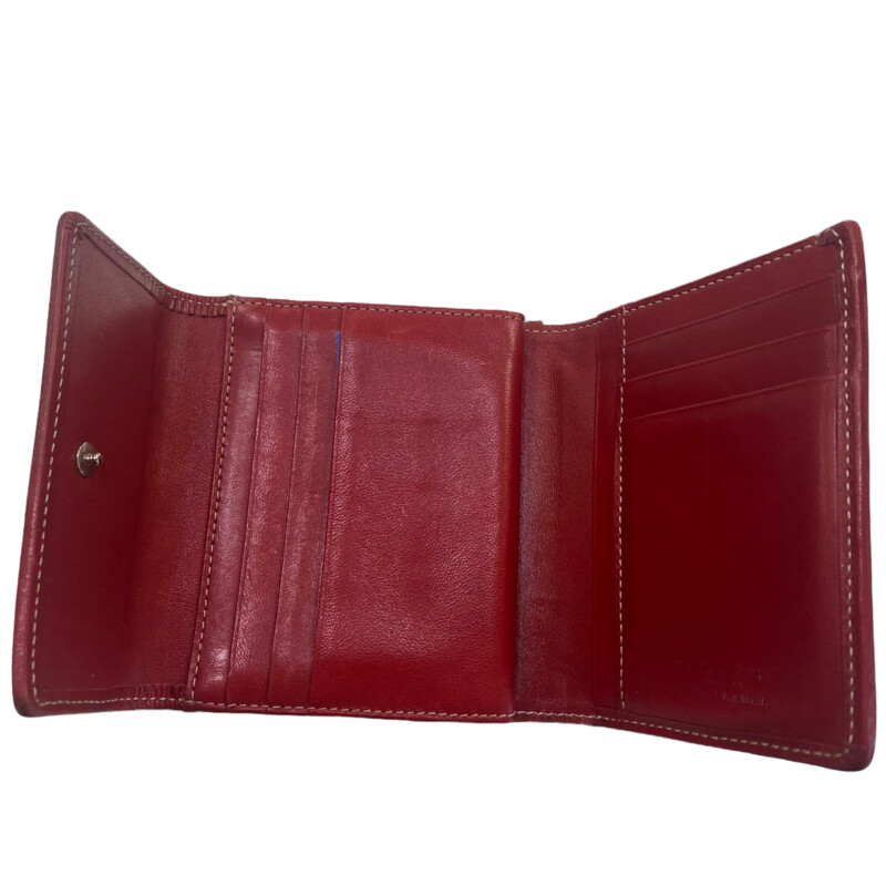 Burberry wallet<br />
red leather interior<br />
clean no cracking<br />
minor wear on outside<br />
vintage piece