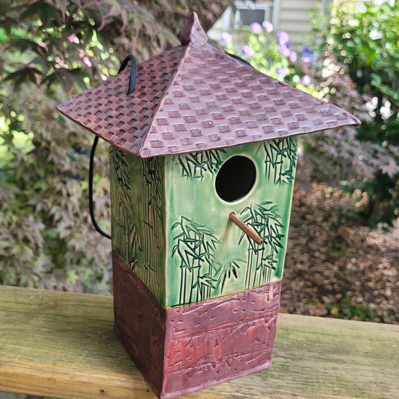 Title: Bamboo Birdhouse
Artist:  Pam Gray
Media:  Pottery
Dimensions:  12 in. x4 in x 4 in
Description:  Ceramic birdhouse with bamboo design and tile patterned roof.  This birdhouse is designed using Audobon Society specifications for chickadees, wrens and other small birds.  The roof lifts off for easy cleaning.