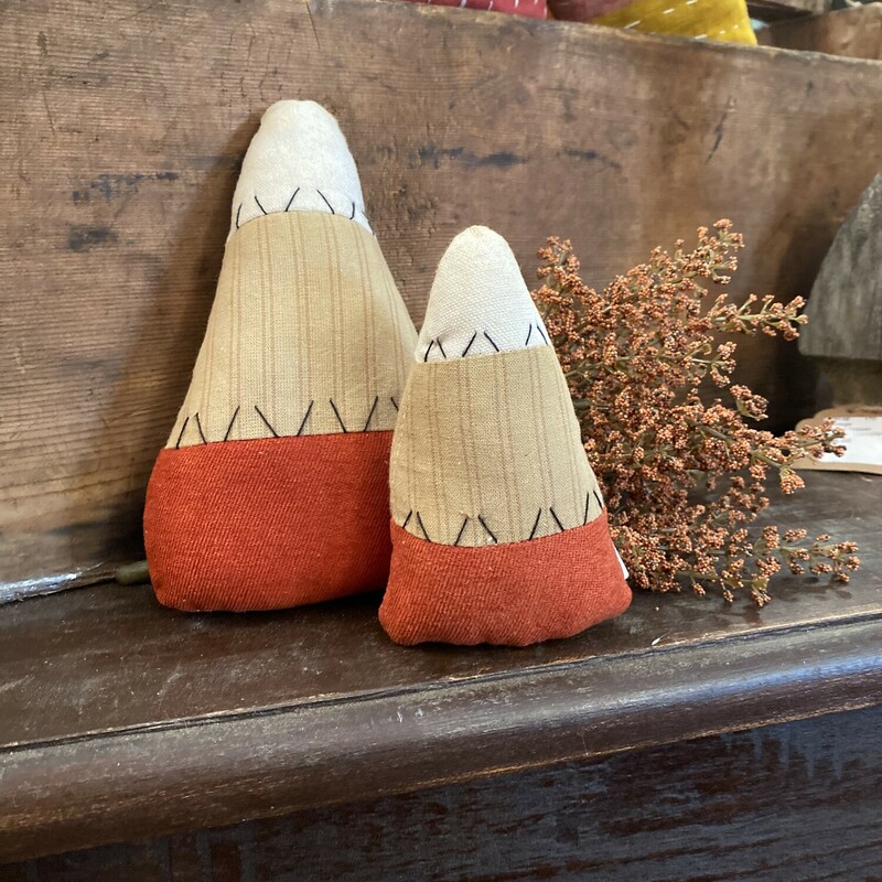 These sweet stuffed candy corn pair is made with colors of primitive ; aged fabric and accented with primitive black stitching detail.   The larger size is 7 inches high by 5 inches wide. Smaller size is 5 inches high by 3 and a half inches wide.