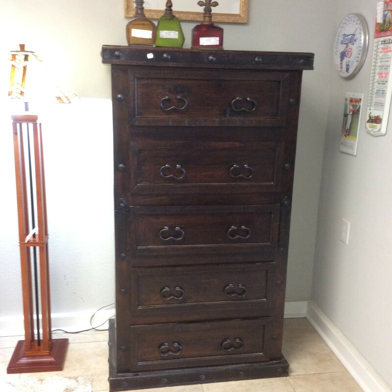 This is a Dark brown, rustic Chest of Drawers. This Chest has 6 drawers, iron button detailing and iron horse shoe style handels.