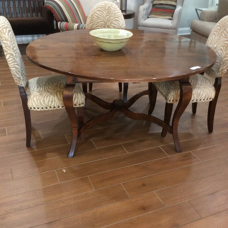 This is a beautiful dark stained round wood table. This table can hold up to 6 people.