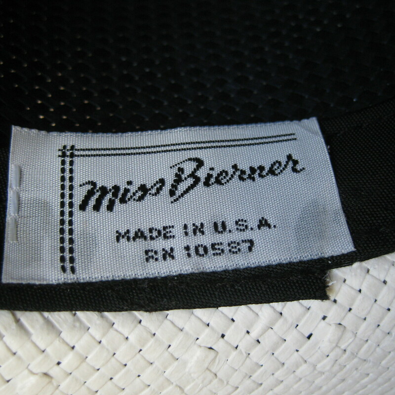 Tailored and glamorous, crisp navy blue and white straw hat by Miss Bernier.
the hat has a medium wide brim, medium tall crown and a fabulous large bow at the back finished with a little gold charm

Very smart.
made in the USA
inner hat band measures 21 5/8 around.
perfect condition!

Thanks for looking!!!
#48983

For safety this hat, while very lightweight itself, will have to be shipped in a box, so the shipping on this item, which is built into the price is unfortunately a bit high.