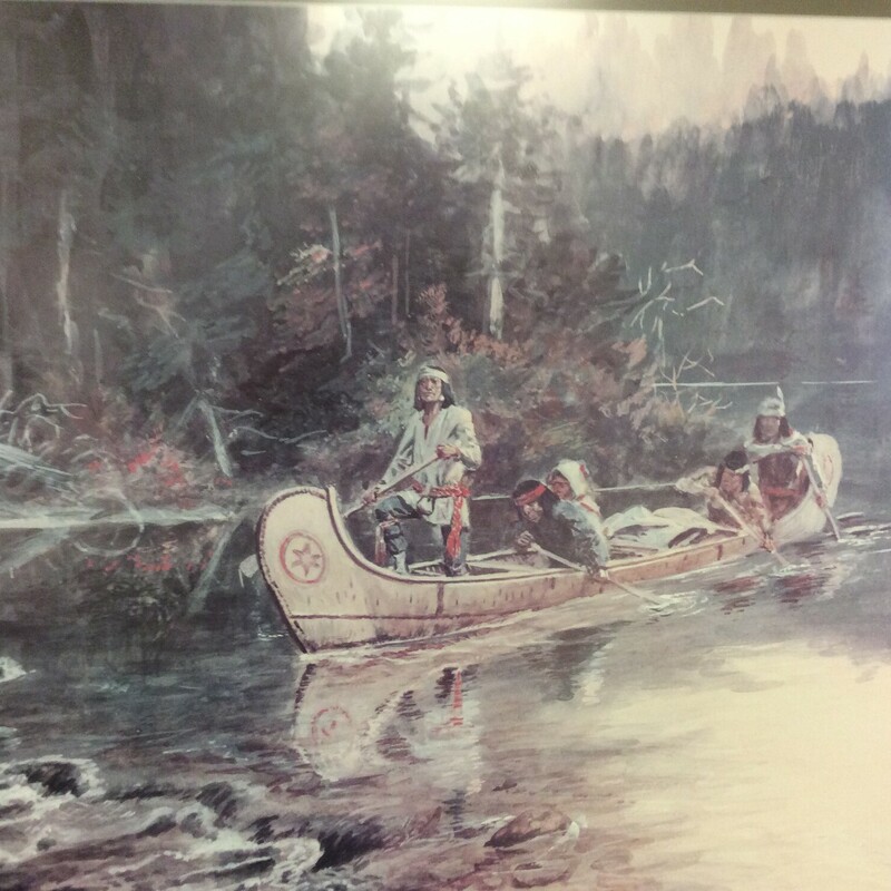 This is a Charles Russell print of \"On the Flathead\" (1864-1926). This is a picture of Native Americans on a conoe ridding down the river. This picture has a wooden frame and green matting.