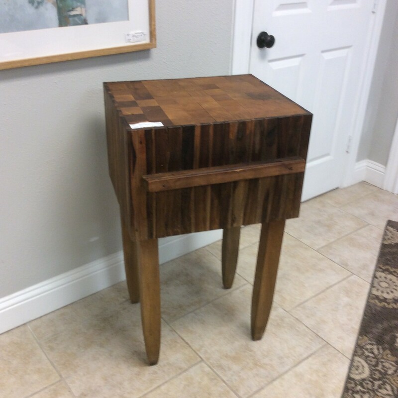 This is a dark wood Butcher Block Table. This table also has a utensil holder on the side.