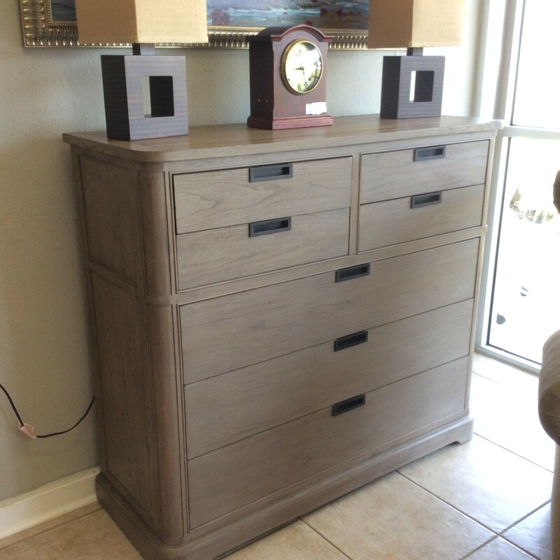This is a Grayish Brown 7 drawers Bassett Chest. This Chest has a Keyboard drawer on the top left and hole for plug ins.
