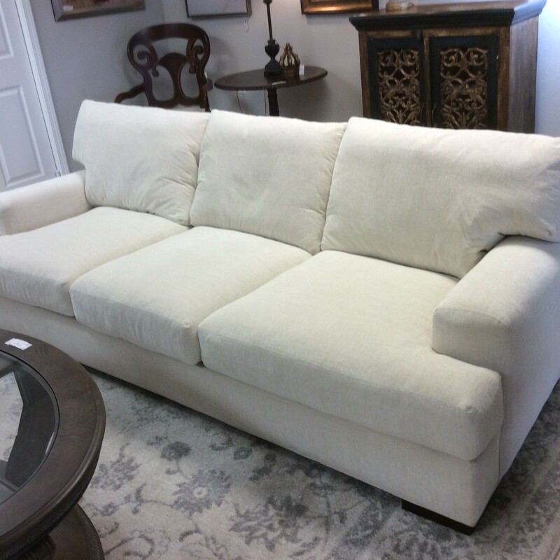 This is a 3 seater, ivroy linen sofa. This sofa was made in the USA by Lee Industries. This sofa has dark brown feet and removable down cushions.