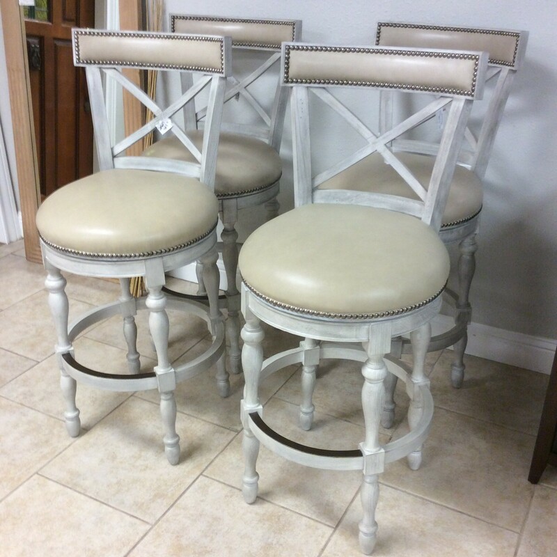 This is a set of 4 Frontgate bar stools. These bar stools have a beautiful grey distressed look, leather seat and backing, nailhead trim, X back and spinal legs.