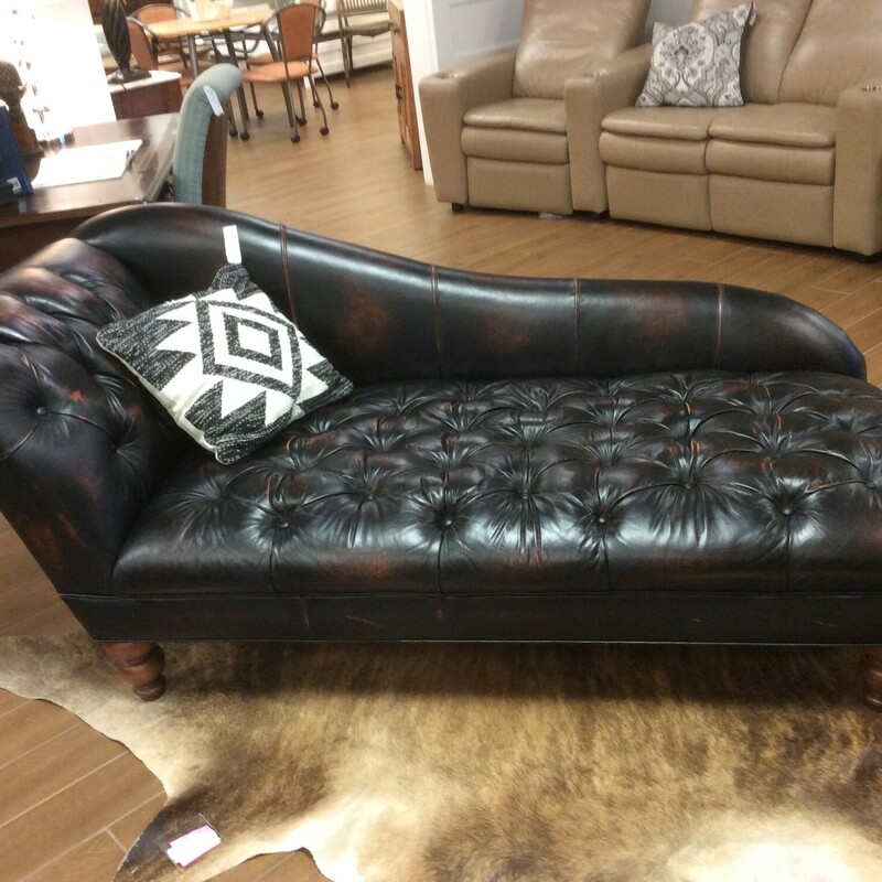 This is a beautiful leather Sam Moore Chaise. This chase is a dark leather with tuffed buttons and spindal feet.