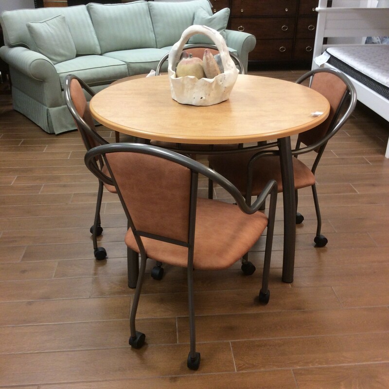 This is a Amisco Dinette Table with 4 rolling chairs. This table is blonde and has metal hardware. The rolling chairs have a linen cushion and backing.