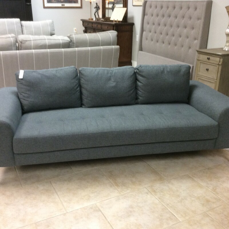 This contemporary style, low profile, sofa is covered in a blue grey fabric with chrome legs.