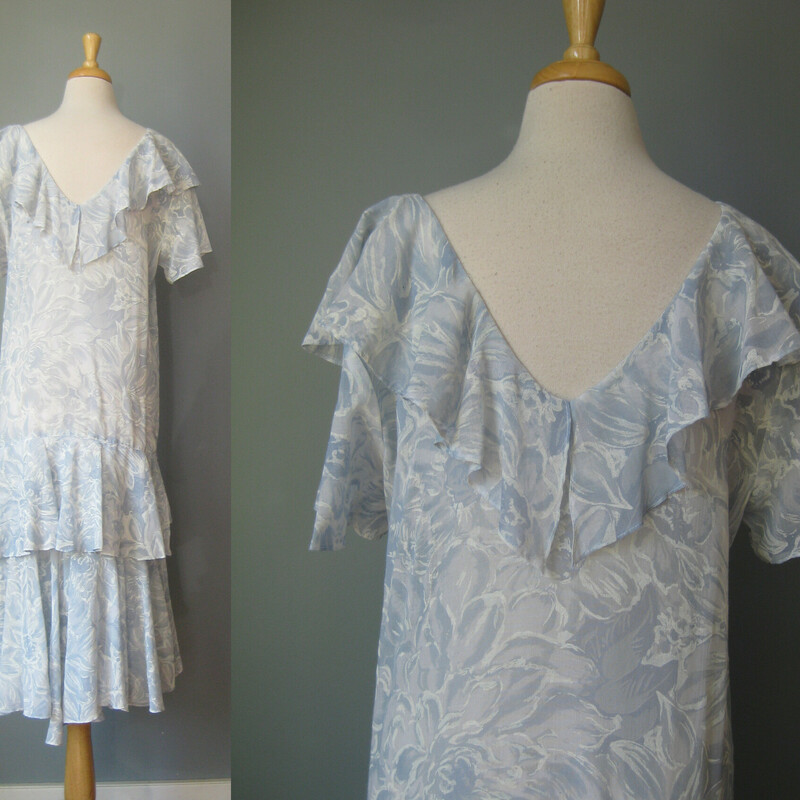 Vtg Starlo Flounced, Blue, Size: 8<br />
Extra lightweight blue dropped waist summer dress with a flouncy cape collar and fluttery sleeves, more flounces down below.  Pale blue with swirly and subtle white floral pattern, it gives the impression of a soft summer sky.<br />
<br />
This dress was made by Star Lo<br />
<br />
The whole effect is very romantic, easy and feminine.<br />
You could wear this for a walk in the garden or dress it up for a  party.<br />
<br />
No closures, goes on over the head.<br />
Unlined, the strategic placement of the flounces means no slip necessary.<br />
<br />
Flat measurements, pls double where appropriate:<br />
Shoulder to shoulder: 16.5<br />
armpit to armpit: 20<br />
waist: 19<br />
hip: 19.25<br />
length: about 44<br />
<br />
thanks for looking!<br />
#43110