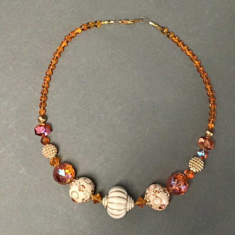 Enamel,Amber Glass, Ochre, Size: Necklace<br />
 Necklace. Enamel focus beads, Amber<br />
glass, and gold beads. $60.00<br />
Hand made by Eileen Settle