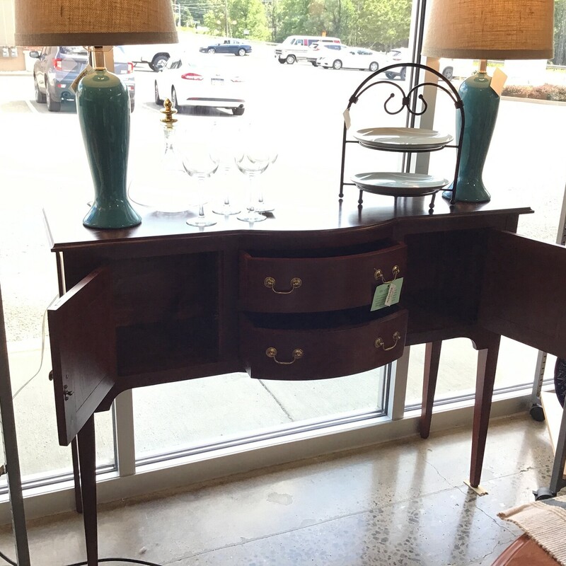 Cherry Server
Crafted by the Tom Seely Furniture Company a high
     quality furniture maker
Two doors open to a spacious cabinet
Two drawers
Spindle legs
Gold pulls and knob
Curved front
Dimensions:  52x16x38