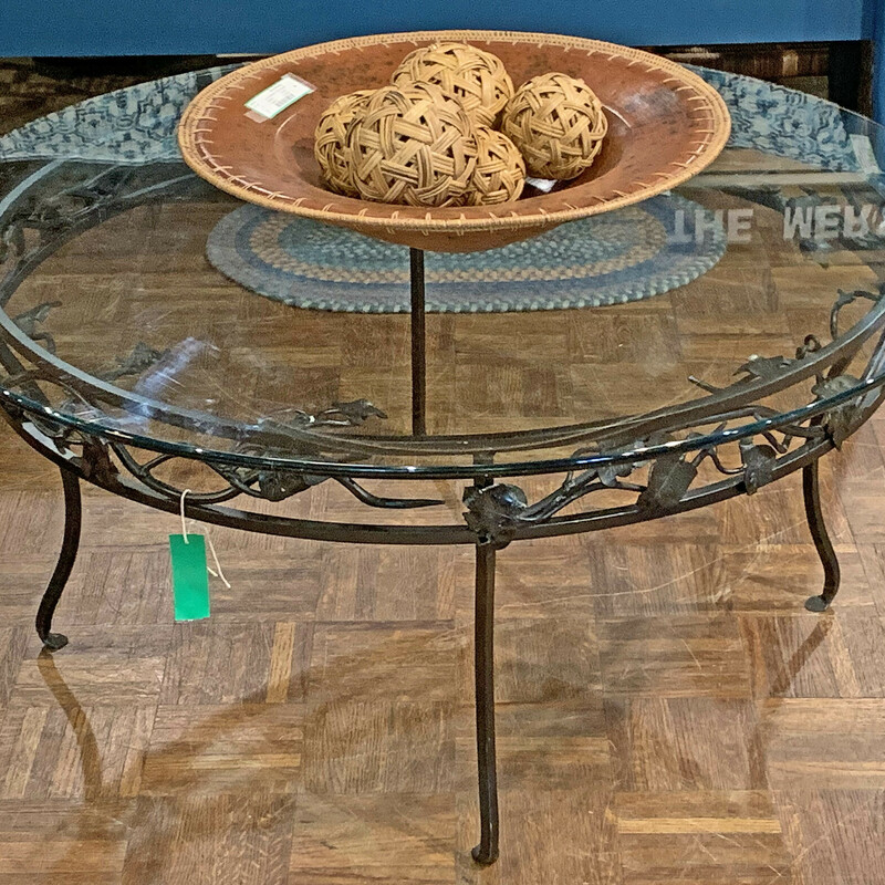 Wrought Iron Rnd Table
Size: 42in round  X 19in Tall
Beautiful custom made wrought iron glass top table made right here in Bristol, NH!  Obviously, one of a kind.!  The beauty of the table is your ability to see right through it so it could show off a rug or wood floors!
