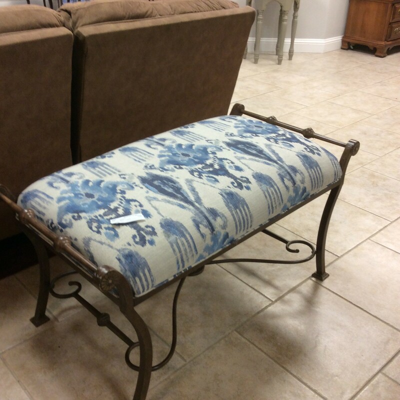 This handsome bench has a large cushion covered in a blue and white Ikat fabric.
