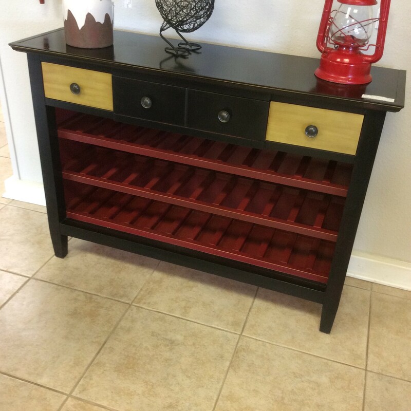 This wine console table has a black and red painted   finish with natural wood accents.