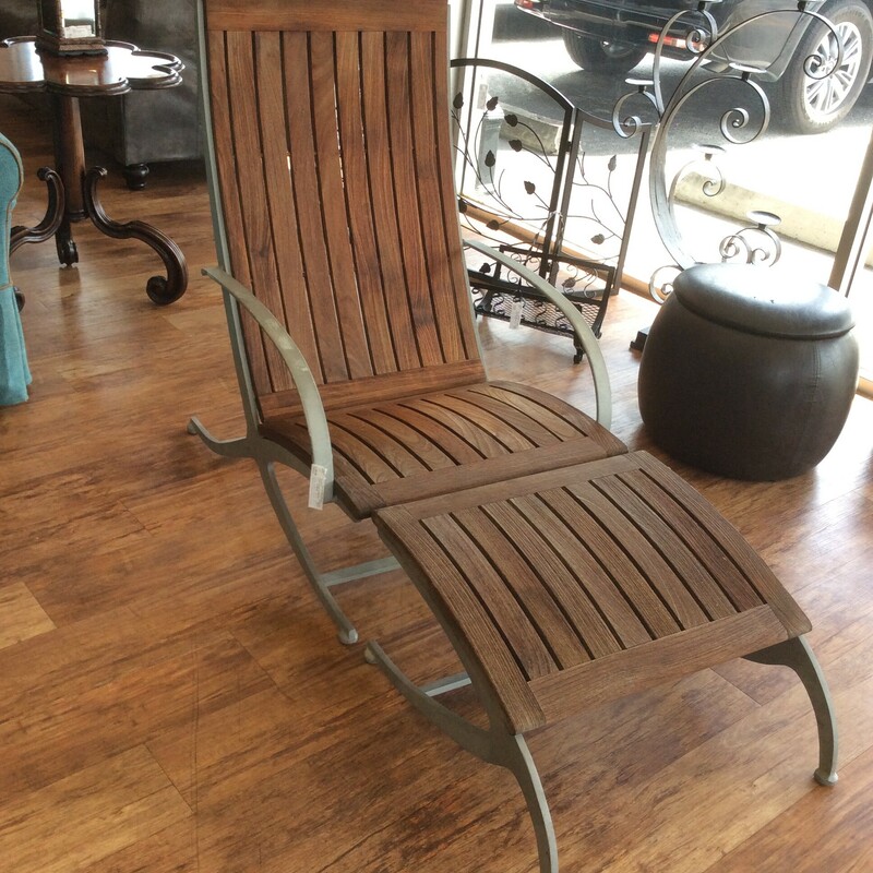 This is a beautiful teakwood lounger & ottoman with metal arms and legs.