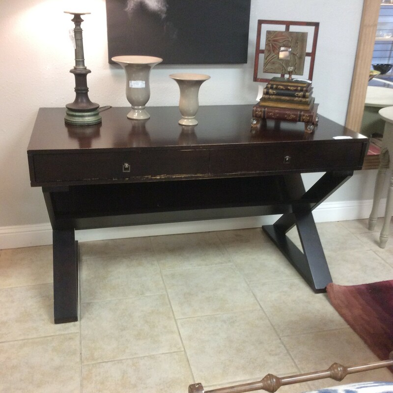 This is a beautiful dark stained studio style desk. This desk features 2 drawers with silver hardware and 1 shelf underneath the top of the desk.