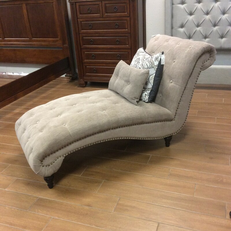 This is a beautiful Gray upholstered, tuffed chaise lounge. This chaise features nailhead trim and includes 1 pillow.